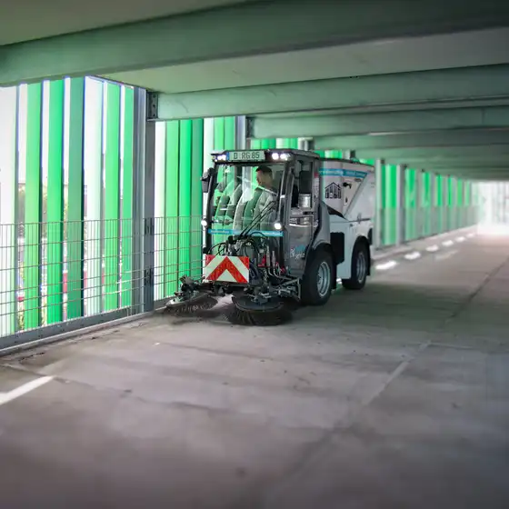Eine Kehrmaschine fährt in einem Parkhaus