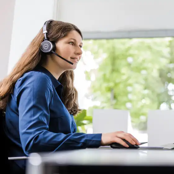 Eine Mitarbeiterin mit Headset